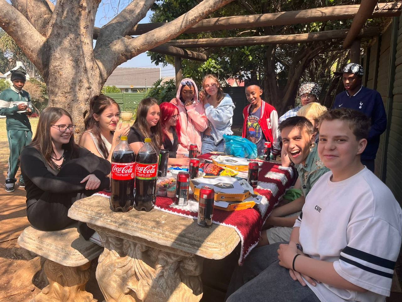 Learners smiling around the picnic table at St. Ronald's Homeschool Tutor Centre