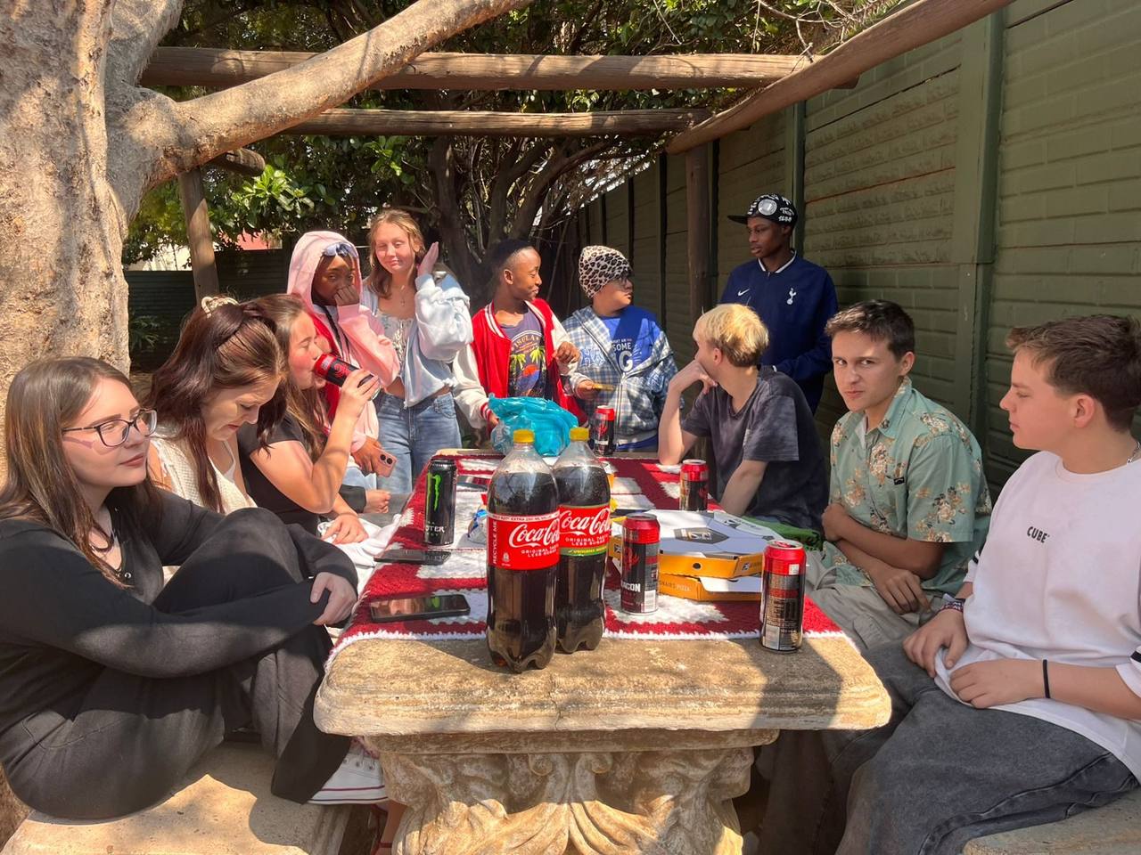 Picnic gathering under the wooden pergola at St. Ronald's Homeschool Tutor Centre