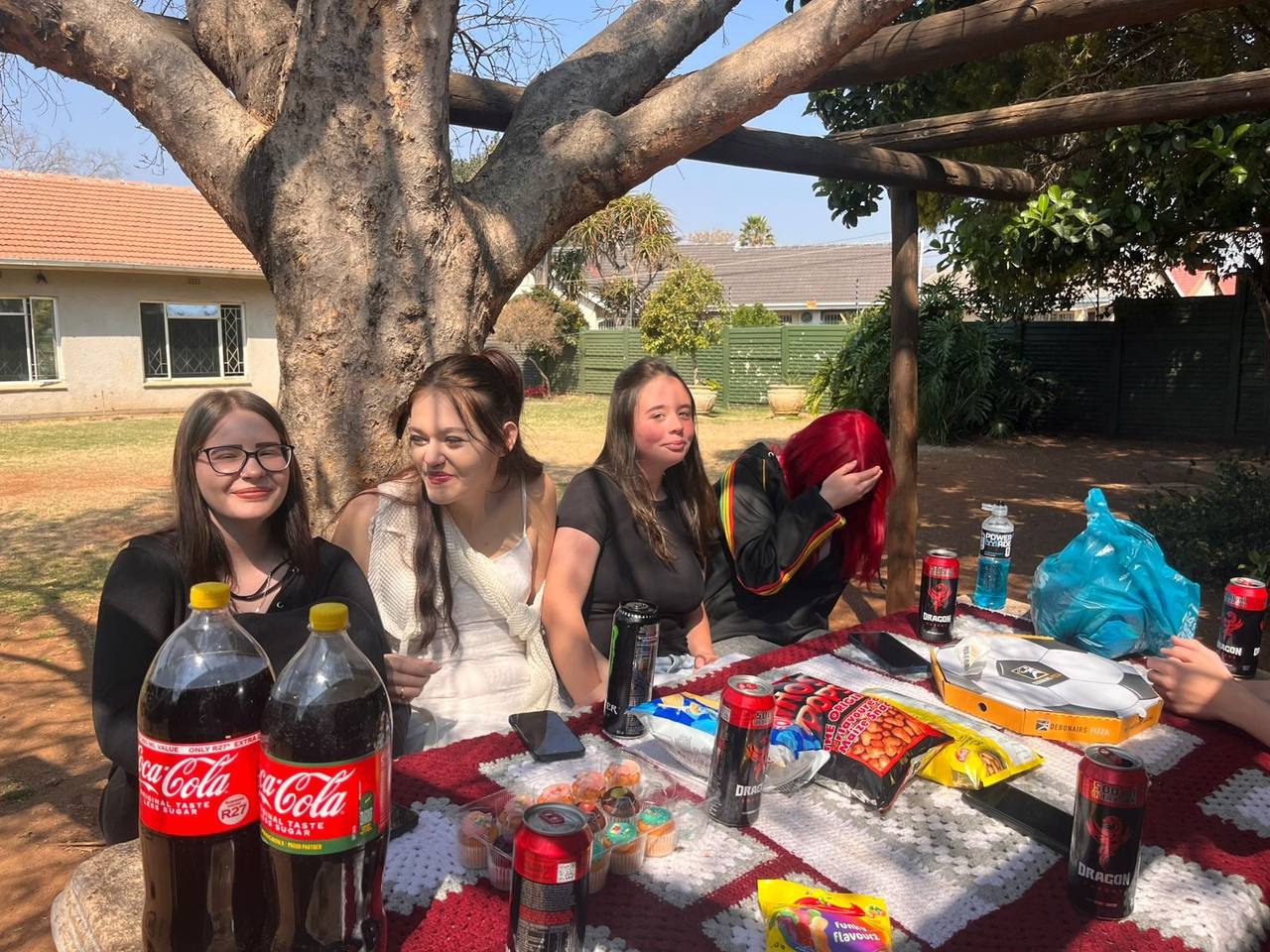 Picnic table with snacks and learners at St. Ronald's Homeschool Tutor Centre